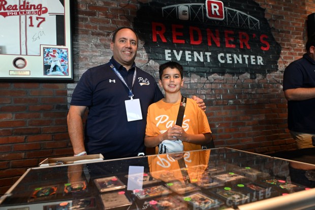 Nick Palladino, CEO of Pal's Sports Cards, the organizer of the event, stands with his son Brock, 13, who is selling cards during the Pennsylvania State Card Show at the Redner's Event Center at FirstEnergy Stadium on Saturday, July 25, 2026. (BILL UHRICH/READING EAGLE)