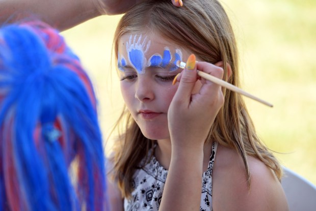 Ava Woiciechowski, 9, has her face painted by Kokol the Clown during the Berks County Star Spangled Spectacular at the county fairgrounds in Bern Township on Saturday, July 4, 2026. (BILL UHRICH/READING EAGLE)