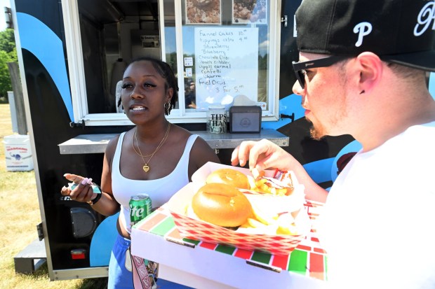 Mike Vasquez and Isa Smith of Reading sample a variety of food during the Berks County Star Spangled Spectacular at the county fairgrounds in Bern Township on Saturday, July 4, 2026. (BILL UHRICH/READING EAGLE)