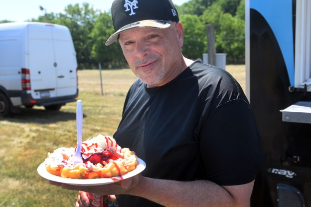 Carlos Vasquez of Reading enjoys some funnel cake during the Berks County Star Spangled Spectacular at the county fairgrounds in Bern Township on Saturday, July 4, 2026. (BILL UHRICH/READING EAGLE)