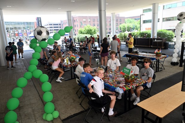 Young soccer fans snack outside the DoubleTree by Hilton hotel before the FIFA Fan Zone World Cup watch party at the Santander Arena on Friday, July 3, 2026. (BILL UHRICH/READING EAGLE)