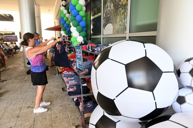Barb Kernen of Collegeville checks out the size of a USA T-shirt outside the DoubleTree by Hilton hotel before the FIFA Fan Zone World Cup watch party at the Santander Arena on Friday, July 3, 2026. (BILL UHRICH/READING EAGLE)