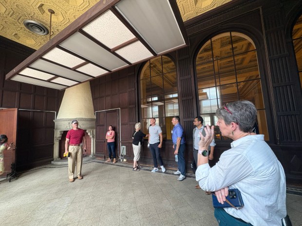 Developer Alan Shuman fields a question from Green Building Alliance Chief Operating Officer Chris Cieslak, right, during a tour of the former Farmers Bank at Fifth and Penn streets that Shuman is redeveloping. (BILL UHRICH/READING EAGLE)