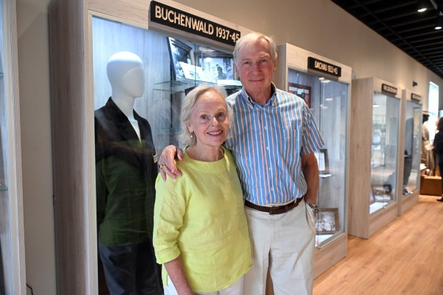 Estee and Peter Pickens of Wayne, Montgomery County, stand at a display of the Buchenwald concentration camp during the dedication of the Berks Holocaust Education Center Museum in Mohnton on Thursday, July 16, 2026. Estee's mother, Hilda Jonisz, escaped from Buchenwald. (BILL UHRICH/READING EAGLE)