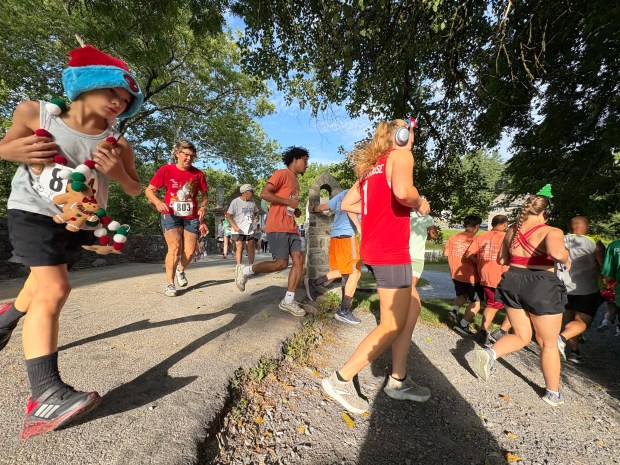 Eli Flores, 8, of Easton, left, rounds the first turn during the Jingle in July. (BILL UHRICH/READING EAGLE)