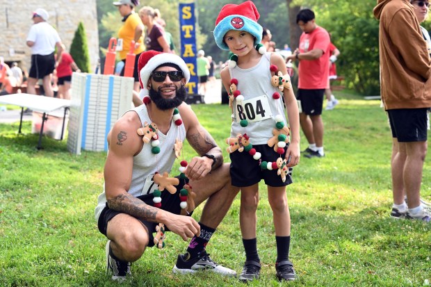 Eric Flores and his son, Eli, 8, of Easton are dressed for the holidays during the Jingle in July (BILL UHRICH/READING EAGLE)