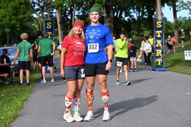 Audra and Cohen Glassmire of Leesport have matching Grinch running socks and holiday outfits prior to the Jingle in July for KidsPeace 5K race on Saturday at Gring's Mill. (BILL UHRICH/READING EAGLE)