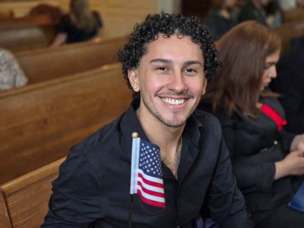 Juan Velasquez of Reading celebrates after becoming a U.S. citizen during a naturalization ceremony Wednesday at the Berks County Courthouse. (DAVID MEKEEL - READING EAGLE)