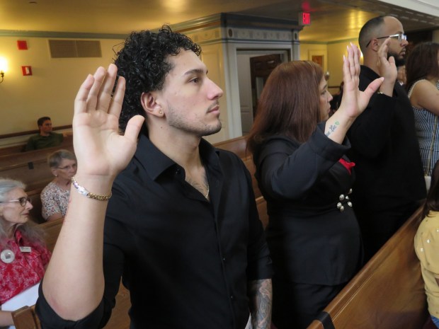 Reading resident Juan Velasquez takes the oath of allegiance during a naturalization ceremony Wednesday at the Berks County Courthouse. (DAVID MEKEEL - READING EAGLE)