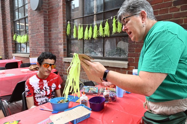 Volunteer Debbie Greenawald helps Daniel Vega, 14, create a puppet during Berks SummerFest at the GoggleWorks Center for the Arts on Saturday, July 11, 2026. (BILL UHRICH/READING EAGLE)