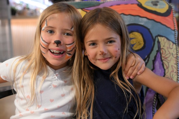 Kaylee, 8, and Kyra, 4, Showalter of Morgantown enjoy their painted new looks during Berks SummerFest at the GoggleWorks Center for the Arts on Saturday, July 11, 2026. (BILL UHRICH/READING EAGLE)