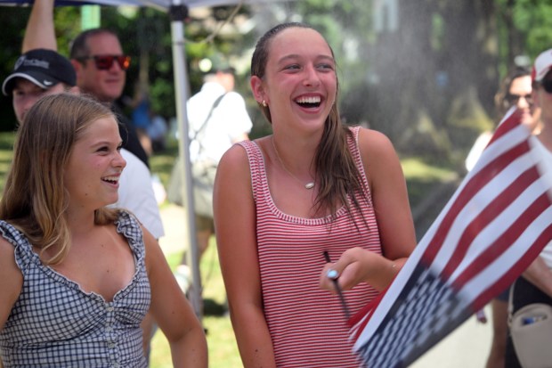 Cousins Annalise McCready 15, visiting from California, and Reagan Babiarz, 14, of Wyomissing keep cool in a misting tent during Wyomissing's Independence Day Parade on Saturday, July 4, 2026. (BILL UHRICH/READING EAGLE)