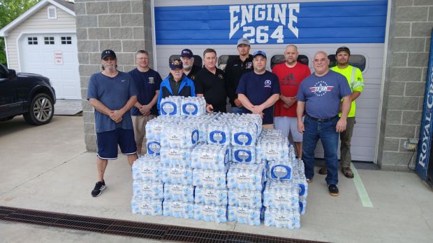 Representatives from all Olyphant fire companies and Kingsbury Lodge representatives gather at Eureka Hose Company for the delivery and distribution of bottled water. (Submitted)