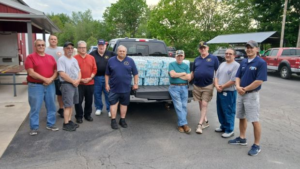 Representatives from Dickson City Station 23, Throop Hose Company No. 1 and Throop Volunteer Hose Company No. 3 gather with Kingsbury Lodge representatives for the delivery and distribution of bottled water. (Submitted)