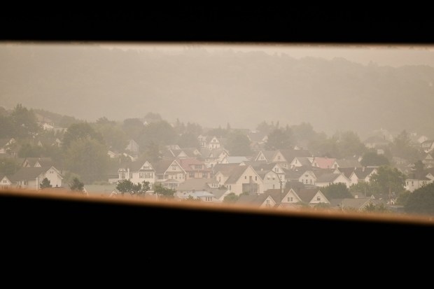 Scranton homes are seen in distance enveloped in haze from the Canadian wildfires Thursday, July 16, 2026. (SEAN MCKEAG / STAFF PHOTOGRAPHER)