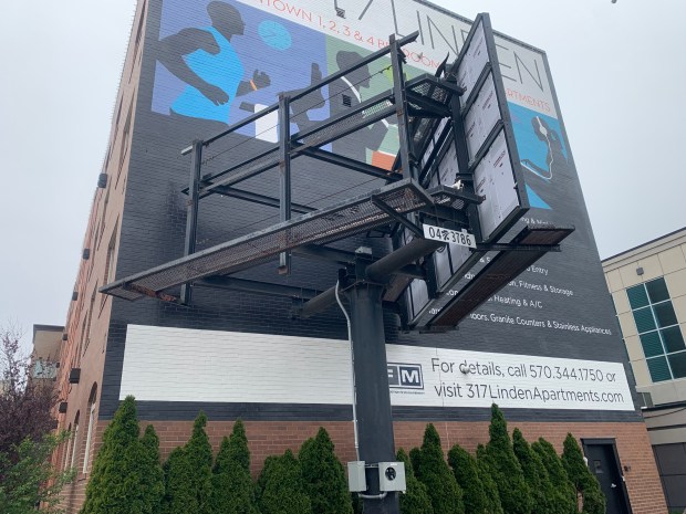 A two-sided billboard sign structure at 320 Mulberry St. in downtown Scranton, shown here on Tuesday, April 28, 2026, is at the crux of a lawsuit by the billboard owner suing the owner of the adjacent building for access to electricity to convert the signs from static to digital displays. (JIM LOCKWOOD / STAFF PHOTO)