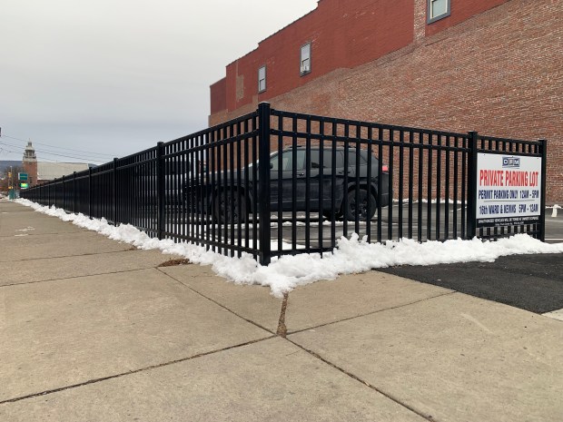 A parking lot and fence owned by Don Mammano at 301-303 Penn Ave. in Scranton on Friday, Dec. 5, 2025. (JIM LOCKWOOD / STAFF PHOTO)