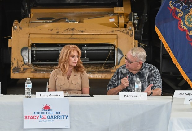 Pennsylvania Treasurer and candiate for governor Stacy Garrity listens to Keith Eckel, owner of Eckel Farms, during a roundtable discussion on agricultural topics at Eckel's farm in Newton Twp. Thursday, July 30, 2026. (SEAN MCKEAG / STAFF PHOTOGRAPHER)