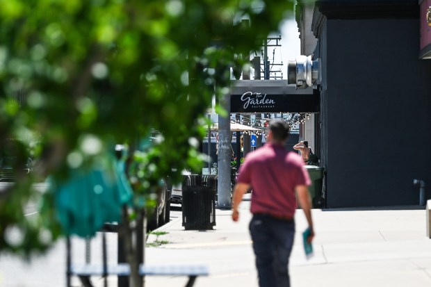 A pedestrian walks near The Garden Restaurant on North Washington Avenue in downtown Scranton Monday, July 13, 2026. (SEAN MCKEAG / STAFF PHOTOGRAPHER)