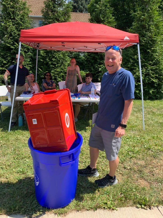 Scranton resident Gary Scott picked up some recycling bins at a "Pop Up City Hall" held on Marion Street at Capouse Avenue in the Green Ridge section of Scranton on Tuesday, June 29, 2021. (JIM LOCKWOOD / STAFF PHOTO)