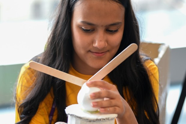 Dipika Basnet, 14, of Scranton, assembles a wind turbine with her team and other members of the University of Success Class of 2030 during an interactive workshop on sustainability and solar cells at the University of Scranton's Leahy Hall in Scranton Wednesday, July 15, 2026. (SEAN MCKEAG / STAFF PHOTOGRAPHER)