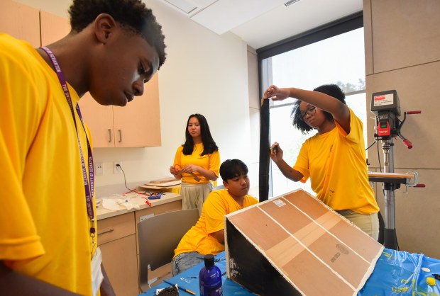 Students Omed Kibingwa, of Scranton, Patty Chen, of Milford, Prayash Magar, of Scranton, and Rachel Garcia, of Scranton, put together a solar panel with other members of the University of Success Class of 2030 during an interactive workshop on sustainability and solar cells at the University of Scranton's Leahy Hall in Scranton Wednesday, July 15, 2026. (SEAN MCKEAG / STAFF PHOTOGRAPHER)