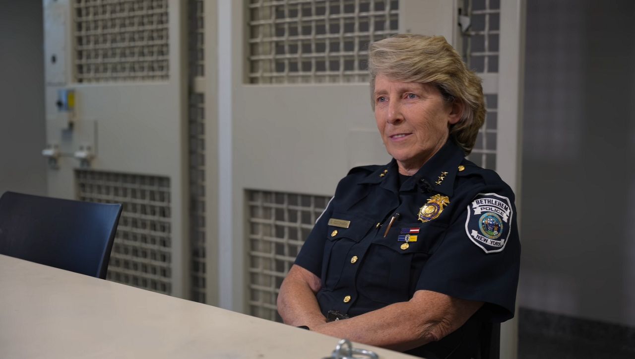 woman in police uniform seated