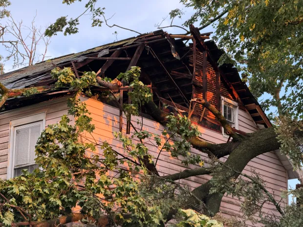 A tree fell onto this house on West Fifth Street in Alburtis, tearing away part of the roof, after severe storms moved through the area Friday evening July 3, 2026. The storms cut power to thousands of customers across the Lehigh Valley amid days of extreme heat. (Rich Rolen/Special to The Morning Call)