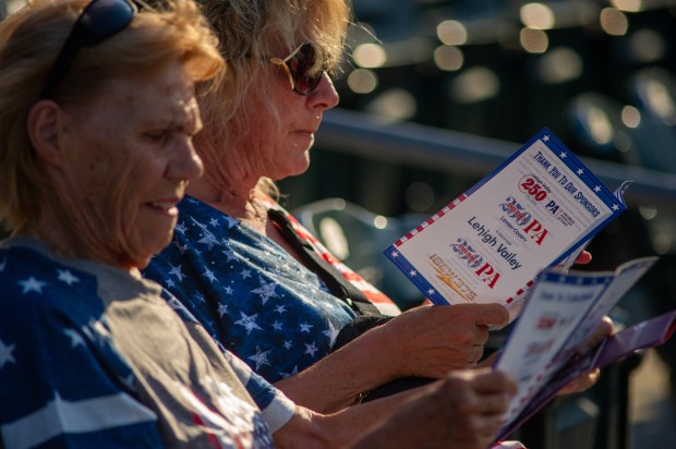 Attendees look over a program Friday, July 3, 2026, during the Liberty Ignited celebration marking America's 250th birthday at Coca-Cola Park in Allentown. (Jonathan Broady/Special to The Morning Call)