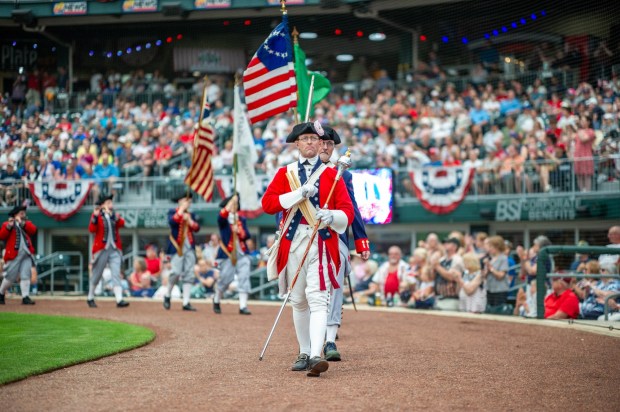 Members of the Bachmann Players perform as a town crier, Benjamin Franklin reads the Declaration of Independence, and Colonial soldiers present a musket salute Friday, July 3, 2026, during the Liberty Ignited celebration marking America's 250th birthday at Coca-Cola Park in Allentown. (Jonathan Broady/Special to The Morning Call)