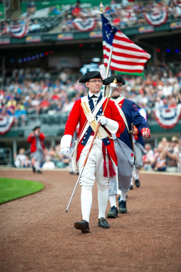 Members of the Bachmann Players perform as a town crier, Benjamin Franklin reads the Declaration of Independence, and Colonial soldiers present a musket salute Friday, July 3, 2026, during the Liberty Ignited celebration marking America's 250th birthday at Coca-Cola Park in Allentown. (Jonathan Broady/Special to The Morning Call)