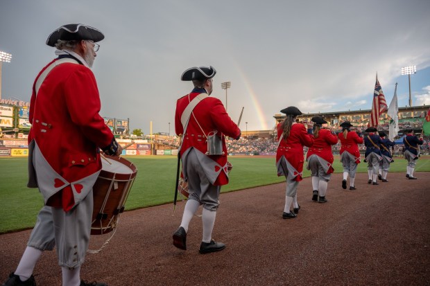 Members of the Bachmann Players perform as a town crier, Benjamin Franklin reads the Declaration of Independence, and Colonial soldiers present a musket salute Friday, July 3, 2026, during the Liberty Ignited celebration marking America's 250th birthday at Coca-Cola Park in Allentown. (Jonathan Broady/Special to The Morning Call)