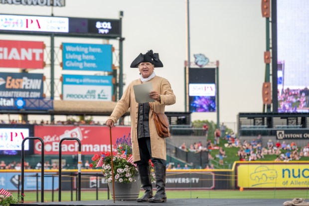 Members of the Bachmann Players perform as a town crier, Benjamin Franklin reads the Declaration of Independence, and Colonial soldiers present a musket salute Friday, July 3, 2026, during the Liberty Ignited celebration marking America's 250th birthday at Coca-Cola Park in Allentown. (Jonathan Broady/Special to The Morning Call)