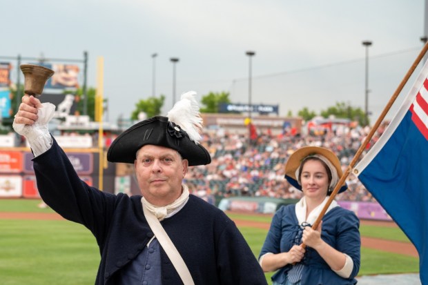 Members of the Bachmann Players perform as a town crier, Benjamin Franklin reads the Declaration of Independence, and Colonial soldiers present a musket salute Friday, July 3, 2026, during the Liberty Ignited celebration marking America's 250th birthday at Coca-Cola Park in Allentown. (Jonathan Broady/Special to The Morning Call)