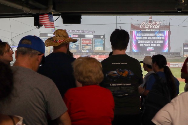 Attendees wait for a thunderstorm to pass during Liberty Ignited at Coca-Cola Park on Friday, July 3, 2026, in Allentown. Part of wider America 250 celebrations happening both in the Lehigh Valley and nationwide, Liberty Ignited featured a Pa. Shakespeare Festival rendition of "Who's on First?", an exhibition of historic American cars by the NB Center for American Automotive Heritage and a life sized paper mache Liberty Bell courtesy of Easton Rotary Club (Jon Chiu/The Morning Call)