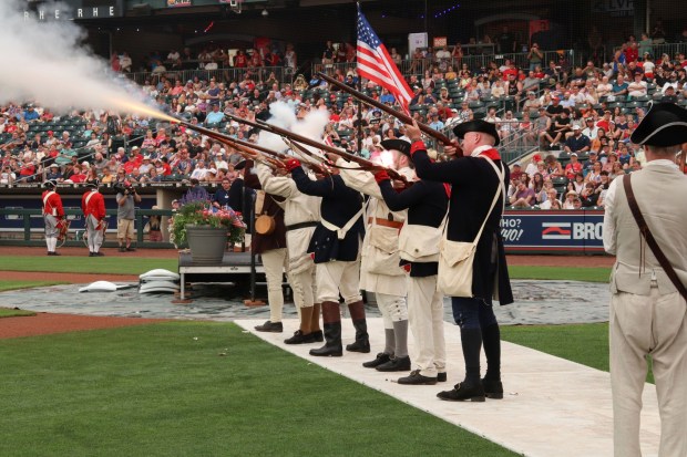 Members of the Bachmann Group dressed in Revolutionary War uniforms fire off a musket salute during Liberty Ignited at Coca-Cola Park on Friday, July 3, 2026, in Allentown. Part of wider America 250 celebrations happening both in the Lehigh Valley and nationwide, Liberty Ignited featured a Pa. Shakespeare Festival rendition of "Who's on First?", an exhibition of historic American cars by the NB Center for American Automotive Heritage and a life sized paper mache Liberty Bell courtesy of Easton Rotary Club (Jon Chiu/The Morning Call)