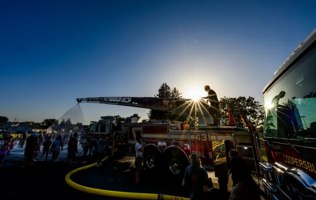 Coopersburg Fire Company fire chief Dave Huber adjusts the sprayer on the ladder truck Thursday, July 2, 2026, during a free community cool off event in Coopersburg. (April Gamiz/The Morning Call)