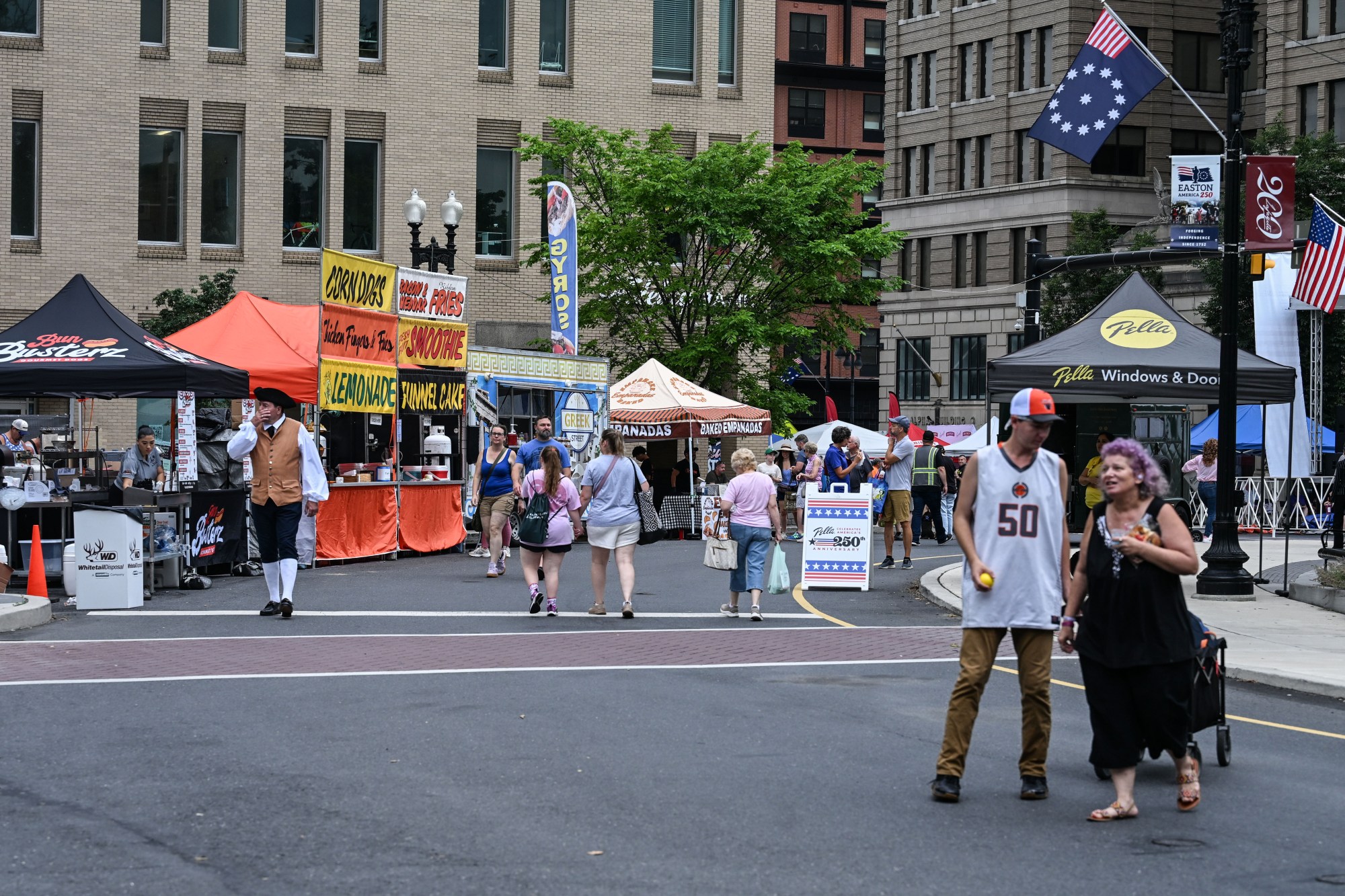 People walk among stands Saturday, July 11, 2026, during the Heritage Day festival in Easton. The festival showcases local and regional history and the heritage of many groups with reenactment events, recreational activities and musical performances. (Jon Chiu/The Morning Call)
