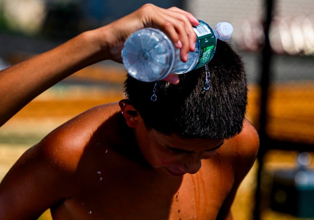 Randy, 12, pours some water on Jayson's, 11, both of Bethlehem, head to cool him down while playing basketball in the hot weather Monday, July 13, 2026, at Friendship Park in Bethlehem. The Lehigh Valley is under a heat advisory from the National Weather Service through 8 p.m. Wednesday.(April Gamiz/The Morning Call)