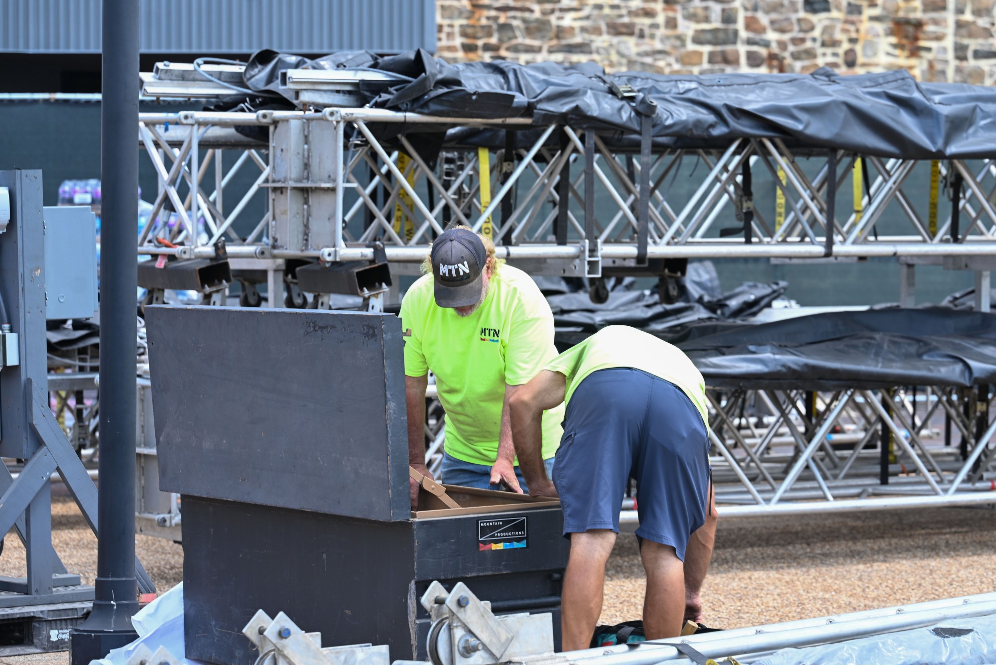 A pair of workers retrieve equipment from a crate during preparations for MusikFest Wednesday, July 22, 2026, in Bethlehem. The 10-day, free music festival in both North and South Side Bethlehem runs July 31-Aug. 9. (Jon Chiu/The Morning Call)