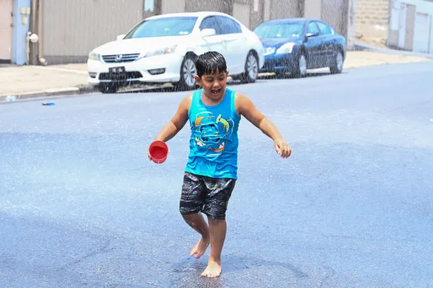 Franco Gonzalez, 6, of Easton plays in water from an open fire hydrant Wednesday, July 15, 2026, at the intersection of South 11th and Butler streets in Easton. Eight of the city's hydrants will be open again from noon to 6 p.m. Thursday to combat soaring temperatures. (Jon Chiu/The Morning Call)