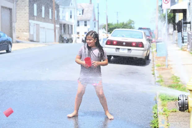 Amy Gonzalez, 8, of Easton plays in water from an open fire hydrant Wednesday, July 15, 2026, WHERE? in Easton. Eight of the city's hydrants will be open again from noon to 6 p.m. Thursday to combat soaring temperatures. (Jon Chiu/The Morning Call)