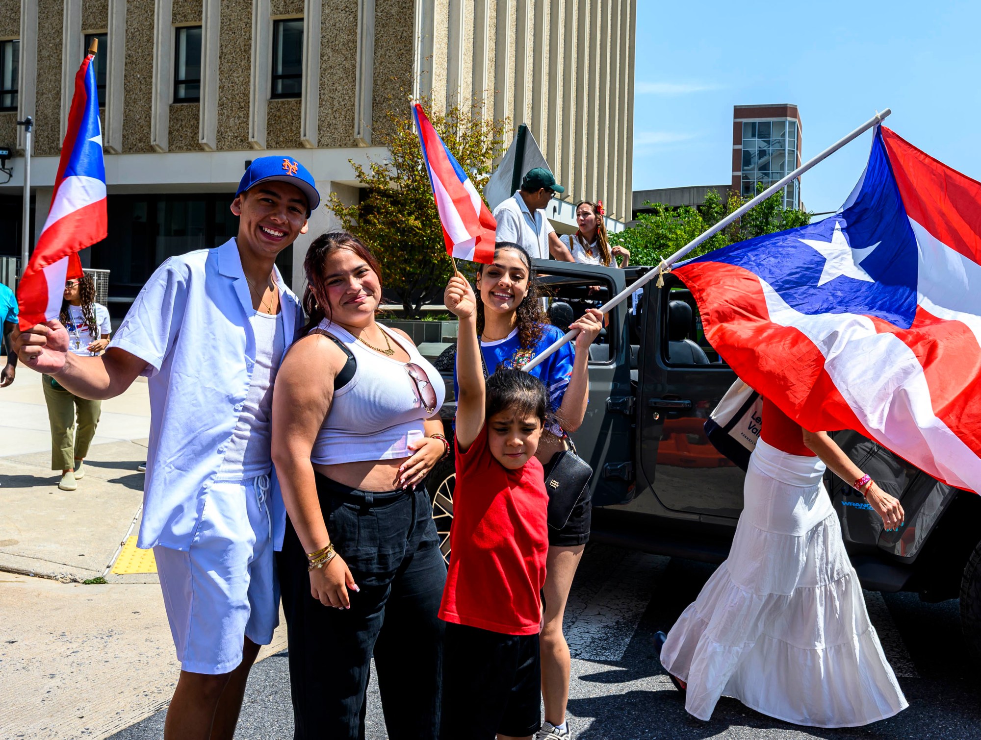 People celebrate during the annual Lehigh Valley Puerto Rican Day Parade on Sunday, July 19, 2026, in Allentown. The day's festivities, sponsored by Puertorrican Cultural Preservation, also included raising the Puerto Rican flag and a festival. (April Gamiz/The Morning Call)