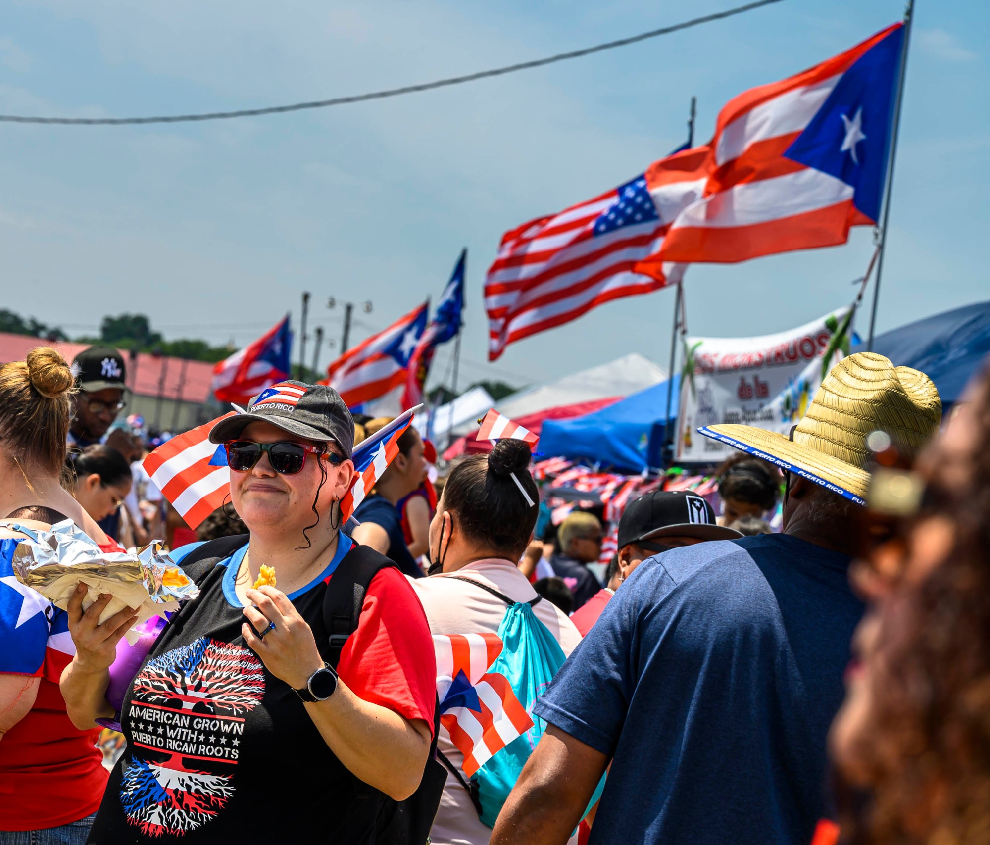 Aurora Alentine enjoys bacalaitos (Puerto Rican salted codfish fritters) during the annual Lehigh Valley Puerto Rican Day Festival on Sunday, July 19, 2026, at the Allentown Fairgrounds. The day's festivities, sponsored by Puertorrican Cultural Preservation, also included raising the Puerto Rican flag and a parade. (April Gamiz/The Morning Call)