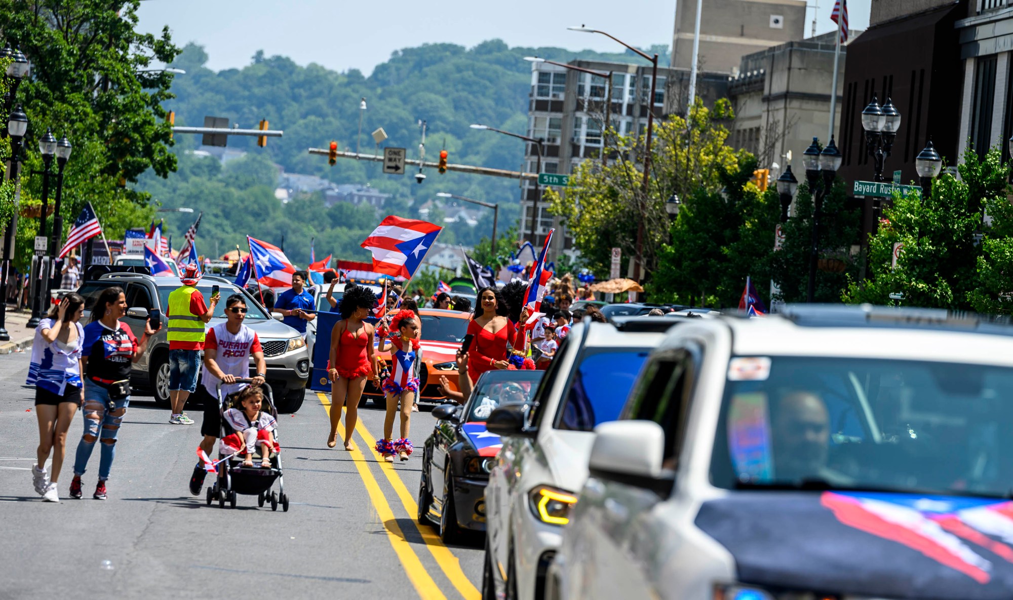 People celebrate during the annual Lehigh Valley Puerto Rican Day Parade on Sunday, July 19, 2026, in Allentown. The day's festivities, sponsored by Puertorrican Cultural Preservation, also included raising the Puerto Rican flag and a festival. (April Gamiz/The Morning Call)