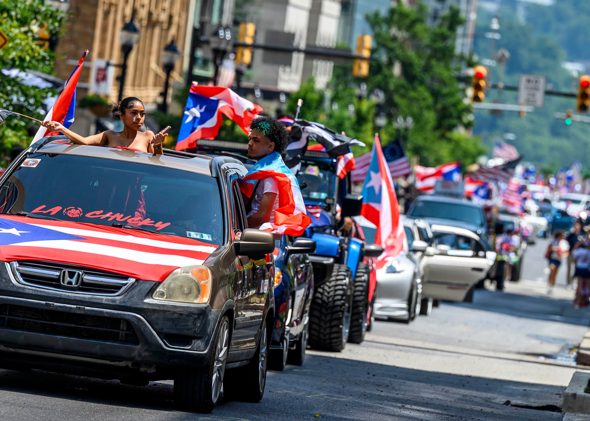 People celebrate during the annual Lehigh Valley Puerto Rican Day Parade on Sunday, July 19, 2026, in Allentown. The day's festivities, sponsored by Puertorrican Cultural Preservation, also included raising the Puerto Rican flag and a festival. (April Gamiz/The Morning Call)