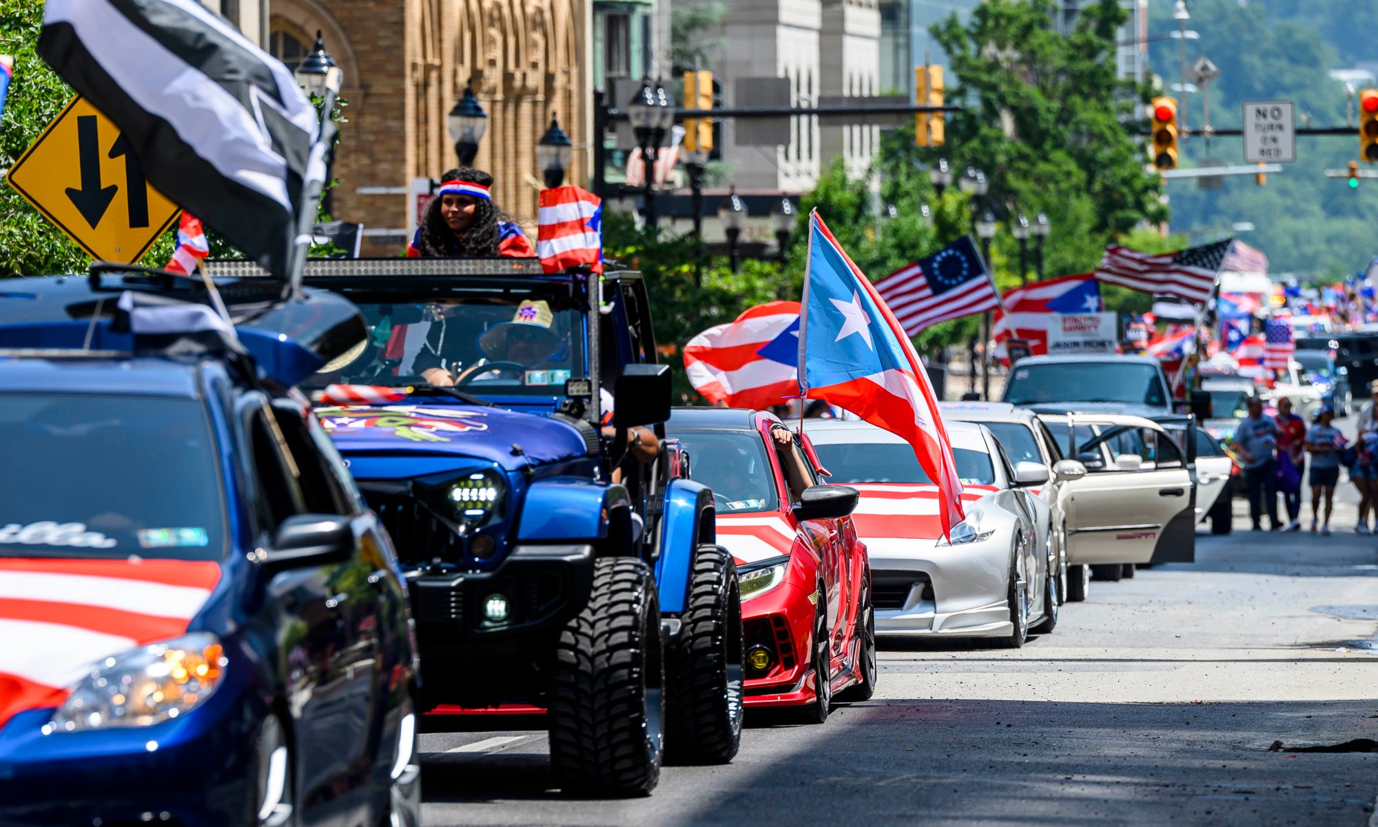 People celebrate during the annual Lehigh Valley Puerto Rican Day Parade on Sunday, July 19, 2026, in Allentown. The day's festivities, sponsored by Puertorrican Cultural Preservation, also included raising the Puerto Rican flag and a festival. (April Gamiz/The Morning Call)