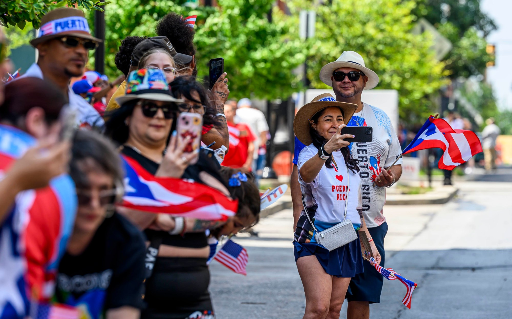 People celebrate during the annual Lehigh Valley Puerto Rican Day Parade on Sunday, July 19, 2026, in Allentown. The day's festivities, sponsored by Puertorrican Cultural Preservation, also included raising the Puerto Rican flag and a festival. (April Gamiz/The Morning Call)