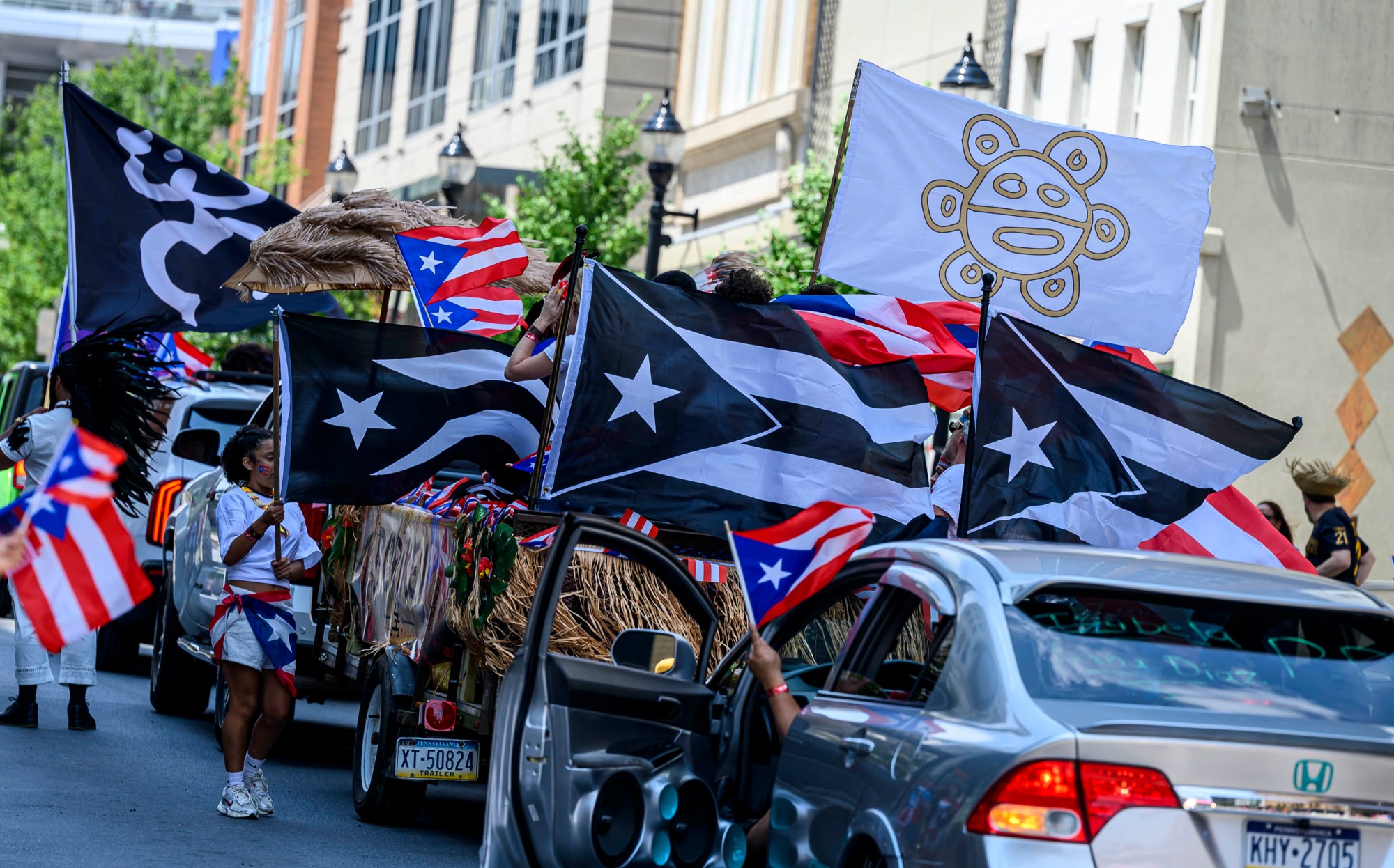 People celebrate during the annual Lehigh Valley Puerto Rican Day Parade on Sunday, July 19, 2026, in Allentown. The day's festivities, sponsored by Puertorrican Cultural Preservation, also included raising the Puerto Rican flag and a festival. (April Gamiz/The Morning Call)