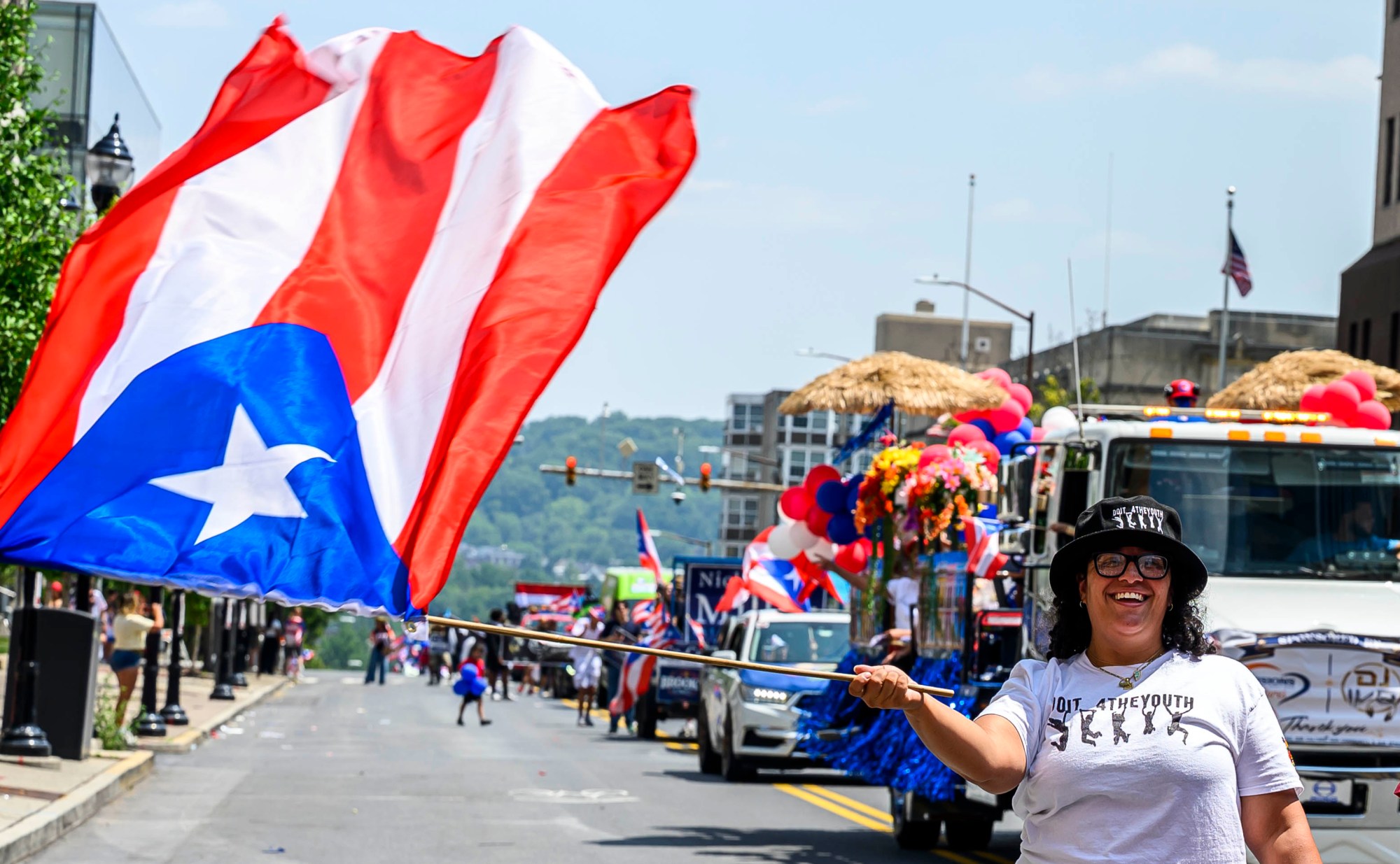 People celebrate during the annual Lehigh Valley Puerto Rican Day Parade on Sunday, July 19, 2026, in Allentown. The day's festivities, sponsored by Puertorrican Cultural Preservation, also included raising the Puerto Rican flag and a festival. (April Gamiz/The Morning Call)